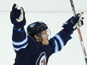 Winnipeg Jets' Nikolaj Ehlers' (42) celebrates his goal against Calgary Flames goaltender Joni Ortio (37) during first period of NHL pre-season game action in Winnipeg on Thursday, October 1, 2015. THE CANADIAN PRESS/John Woods