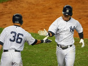 New York Yankees right fielder Carlos Beltran (36) congratulates teammate Robert Refsnyder (64) on his home run against the Boston Red Sox at Yankee Stadium. (Anthony Gruppuso/USA TODAY Sports)