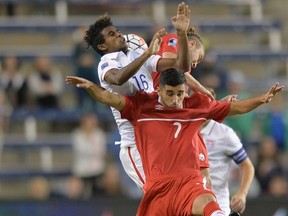 Mauro Eustaquio (7) of Canada appears to get the worst of this battle for the ball during a CONCACAF Olympic qualifying match between the United States and Canada on Oct. 1, 2015 in Kansas City, Kan. (MICHAEL B. THOMAS/AFP)