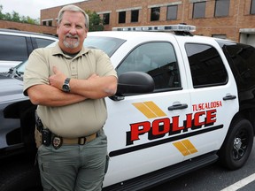 This photo taken Wednesday, Sept. 30, 2015, in Tuscaloosa, Ala., shows police Capt. Mike Flowers, who is retiring after 35 years without a sick day. (AP Photo/Jay Reeves)