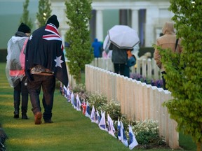 Anzac Day observers walk in a cemetery after a dawn service to mark the 100th anniversary of Anzac (Australian and New Zealand Army Corps) Day at the Australian National Memorial in Villers-Bretonneux, in northern France, on April 25, 2015. (REUTERS/Philippe Wojazer)