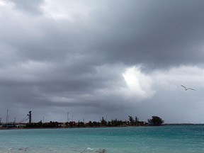 Skies begin to darken as Hurricane Joaquin passes through the region, seen from Nassau, Bahamas, early Friday, Oct. 2, 2015.  (AP Photo/Tim Aylen)
