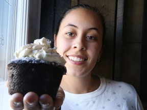 Gino Donato/Sudbury Star
Alexis Fong shows off a cupcake at Salute Coffee Company on Thursday. Fong, a masters student in cancer research at Laurentian University, will be making and selling 500 cupcakes as a fundraiser for the Northern Cancer Foundation. There will be four flavours offered ­-- salted caramel, black forest, strawberry butter cream and brownie avalanche -- all hand-made. The event runs Saturday from 11 a.m. until the cupcakes are sold out at Salute Coffee Company, 2195 Armstrong St.