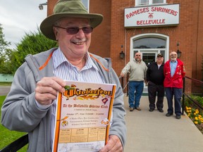 TIM MILLER/THE INTELLIGENCER
Shriner member Otto Nungesser holds up an Oktoberfest flyer outside The Belleville Shrine Club in Belleville. Nungesser, along with (left to right) members Gary Crane,  Bob Ridley and Leonard Bedford are putting on an Oktoberfest celebration at the club on Oct. 17.