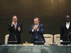 U.N. Secretary-General Ban Ki-moon (L), Lars Lokke Rasmussen (C), co-chair and Danish Prime Minister, and Yoweri Kaguta Museveni, co-chair and Uganda's President, applaud at a plenary meeting of the United Nations Sustainable Development Summit 2015 at United Nations headquarters in Manhattan, New York, September 25, 2015. World leaders on Friday adopted the most sweeping agenda ever of global goals to combat poverty, inequality and climate change, described by the United Nations secretary-general as "a to-do list for people and planet." REUTERS/Mike Segar