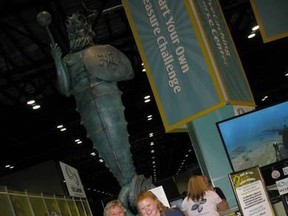 Nancy Easterbrook (left) and Michelle Wetton stand near the Guardian of the Reef statue before it was sunk near Easterbrook's dive shop in Grand Cayman last year.