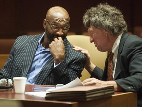 Former NFL player Irving Fryar, left, listens to attorney Michael Gilberti in court Tuesday, July 21, 2015, in Mount Holly, N.J. (Clem Murray/The Philadelphia Inquirer via AP, Pool)