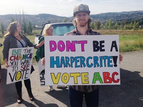Saleem (Tristan) Carr stands with a group of protestors outside a campaign event for Conservative leader Stephen Harper in Kamloops, B.C., September 15, 2015. Conservative Prime Minister Stephen Harper is so out of favour with some voters that they say they are prepared to back a political party they don't usually support just to unseat him in the Oct. 19 general election. (REUTERS/Julie Gordon)