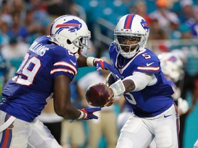 Buffalo Bills quarterback Tyrod Taylor (5) hands the ball to running back Karlos Williams (29) against the Miami Dolphins, Sunday, Sept. 27, 2015 in Miami Gardens, Fla. (AP Photo/Wilfredo Lee)