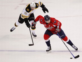 Washington Capitals defenceman Mike Green skates with the puck as Boston Bruins right wing Reilly Smith chases in the first period at Verizon Center in Washington on April 8, 2015. (Geoff Burke/USA TODAY Sports)