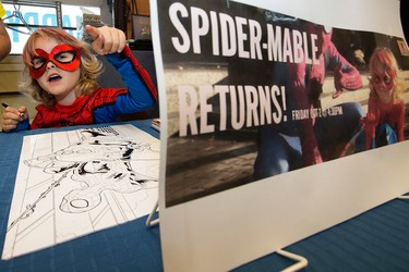 Mable "Spider-Mable" Tooke, (6) looks at the line of fans waiting for her autograph as she signs original Spider-Mable illustrations (created by James Clement) at Happy Harbour Comics, 10729 - 104 Ave., in Edmonton Alta. on Friday Oct. 2, 2015. Organizers hoped to raise $5,000 for the Leukemia and Lymphoma Society of Canada. David Bloom/Edmonton Sun/Postmedia Network