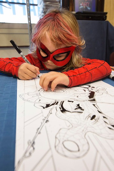 Mable "Spider-Mable" Tooke, (6) signs original Spider-Mable illustrations (created by James Clement) at Happy Harbour Comics, 10729 - 104 Ave., in Edmonton Alta. on Friday Oct. 2, 2015. Organizers hoped to raise $5,000 for the Leukemia and Lymphoma Society of Canada. David Bloom/Edmonton Sun/Postmedia Network