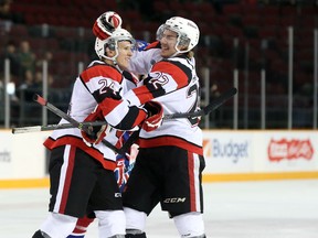 Ottawa 67's defencemen Evan de Haan, right, and Nevin Guy celebrate de Haan's first-period goal against the Hamilton Bulldogs at TD Place on Friday, Sept. 10, 2015. (Chris Hofley/Ottawa Sun)