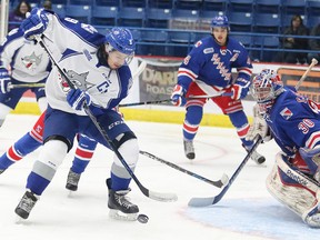 Sudbury Wolves captain Danny Desrochers tries to control the puck in front of Kitchener Rangers goaltender Dawson Carty during OHL action at Sudbury Community Arena on Friday night.