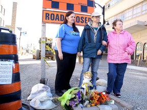 Pauline Clement, Noella Messier and Yvonne Lentir stand next to a memorial they created for the pedestrian killed in Wednesday's accident at Beech and Elgin streets in Sudbury, Ont. on Friday October 2, 2015. Gino Donato/Sudbury Star/Postmedia Network