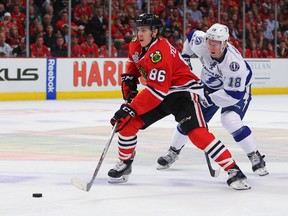 Teuvo Teravainen of the Blackhawks, holding off Bolts' Ondrej Palat during last year's Stanley Cup final, could be destined for second-line centre alongside Patrick Kane, but will likely open the season on the third. (US TODAY SPORTS)