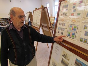 Al Gualtieri, with the Sarnia Stamp Club, looks over one of the displays at the group's annual stamp show held at Sarnia Collegiate on Saturday October 3, 2015 in Sarnia, Ont. Paul Morden/Sarnia Observer/Postmedia Network