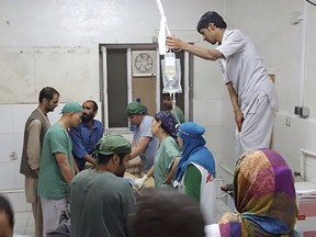 Afghan (MSF) surgeons work inside a Medecins Sans Frontieres (MSF) hospital after an air strike in the city of Kunduz, Afghanistan in this October 3, 2015 MSF handout photo. The U.S. military on Saturday acknowledged it may have bombed a hospital run by medical aid group Medecins Sans Frontieres in the Afghan city of Kunduz in an air strike that killed at least nine people and wounded 37. (REUTERS/Medecins Sans Frontieres/Handout via Reuters)