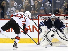 Ottawa Senators' Curtis Lazar takes a shot on Winnipeg Jets goalie  Ondrej Pavelec during pre-season NHL hockey action in Winnipeg on Tuesday, September 29, 2015. THE CANADIAN PRESS/Trevor Hagan