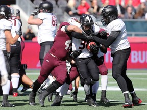 Carleton Ravens running back Jahvari Bennett tries to break tackles during the annual Panda Game against the University of Ottawa Gee-Gees at TD Place on Saturday, Oct. 3 2015 (Chris Hofley/Ottawa Sun)