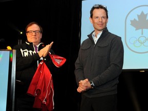 Chef de mission Jean-Luc Brassard, right, is seen here in 2013 with former Canadian Olympic Committee president Marcel Aubut, who resigned Saturday amid allegations of sexual harassment. (Postmedia Network/File)