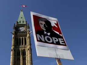 A sign featuring an illustration of Conservative leader Stephen Harper is pictured during a singalong performance of "Harperman," a protest song against Harper, on Parliament Hill in this Sept. 17, 2015, file photo. Harper is so out of favour with some voters that they say they are prepared to back a political party they don't usually support just to unseat him in the Oct. 19, 2015 federal election.  
REUTERS/Chris Wattie/Files