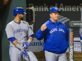 Toronto Blue Jays manager John Gibbons, right, and Jose Bautista, left, were two initial pieces GM Alex Anthopoulos had a hand in bringing to Toronto before the team became a division winner. (REUTERS/Doug Kapustin)