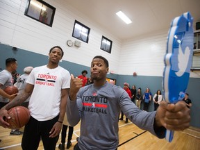 Toronto Raptors' Kyle Lowry, right, uses a Twitter mirror to take a photo of himself and teammate DeMar DeRozan while helping run an NBA FIT Clinic at Kinmount Boys and Girls Club, where the team also unveiled a refurbished basketball court, in Vancouver, B.C., on Friday October 2, 2015. The Raptors are scheduled to play the Los Angeles Clippers in an NBA preseason basketball game Sunday in Vancouver. (THE CANADIAN PRESS/Darryl Dyck)