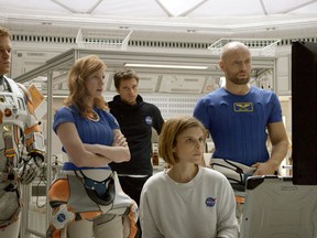 In this photo provided by Twentieth Century Fox, Matt Damon, from left, as Astronaut Mark Watney, Jessica Chastain as Melissa Lewis, Sebastian Stan as Chris Beck, Kate Mara as Beth Johanssen, and Aksel Hennie as Alex Vogel, appear in a scene in the film, "The Martian." The movie releases in U.S. theaters on Oct. 2, 2015. (Twentieth Century Fox via AP)