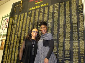 London, Ont. jazz singer Denise Pelley, left, and Detroit, MI-area quilter April Shipp, are pictured in front of a quilt titled 'Strange Fruit - A Century of Lynching and Murder' that was on display for the first time in Canada in Dresden, Ont. on Saturday October 3, 2015, during a wrap up event for the second annual Dresden Plate Quilt Festival. Ellwood Shreve/Chatham Daily News/Postmedia Network