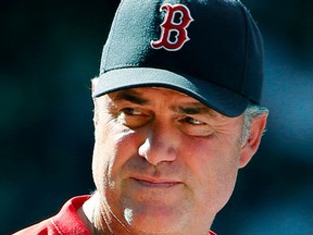 FILE - In this Aug. 2, 2015, file photo, Boston Red Sox manager John Farrell watches action during the eighth inning of a baseball game against the Tampa Bay Rays at Fenway Park in Boston. The Boston Red Sox said Sunday, Oct. 4, 2015, Farrell will be back next season after leaving the team to undergo cancer treatment. (AP Photo/Winslow Townson, File)