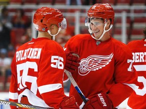 Detroit Red Wings left wing Teemu Pulkkinen (56) and center Dylan Larkin, right, celebrate after the Red Wings defeated the Pittsburgh Penguins 6-1 in a preseason NHL hockey game in Detroit on Thursday, Sept. 24, 2015. Both players had two goals apiece. (AP Photo/Paul Sancya)