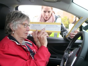 Occupational therapy student Erin Roach (right) assists driver Emily Williamson to measure her sight lines and steering wheel angle during last year's Carfit program sponsored by CAA in Winnipeg, Man. Sunday, Oct. 4, 2015. The program is intended to assist older drivers to feel comfortable and safe in their vehicles. (Brian Donogh/Winnipeg Sun/Postmedia Network)