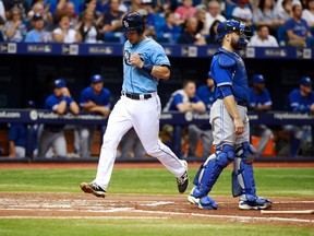 Tampa Bay Rays catcher Luke Maile (46) scores a run as Toronto Blue Jays catcher Russell Martin (55) looks on during the first inning at Tropicana Field. Kim Klement-USA TODAY Sports