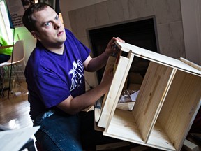 Brad Fremmerlid of Made By Brad puts together a piece of furniture at Little Brick Cafe in Edmonton, Alta. on Sunday, Oct. 4, 2015. Four businesses created for and by entrepreneurs with significant autism came together to show off their products and services. Codie McLachlan/Edmonton Sun/Postmedia Network