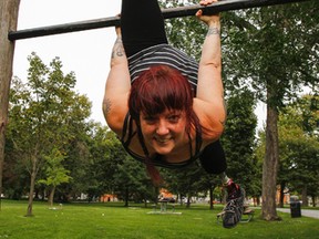 Erin Ball, a local circus performer and coach, is able to do a few tricks in City Park on Friday. More than 11 months after losing both of her lower legs, Ball is excited to be back performing and training and is looking for help in raising funds for a procedure that would give her new legs to perform on. (Julia McKay/The Whig-Standard)