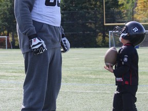Five-year-old Alexis Gagnon can't get enough of the Ottawa RedBlacks and on Sunday, Oct. 4, 2015 in Gatineau, he met some of his heroes, including offensive lineman SirVincent Rogers.
TIM BAINES/OTTAWA SUN