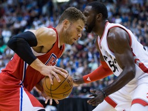 Los Angeles Clippers' Blake Griffin, left, drives to the basket past Toronto Raptors' Patrick Patterson during the first half of a pre-season NBA basketball game in Vancouver, B.C., on Sunday October 4, 2015. THE CANADIAN PRESS/Darryl Dyck