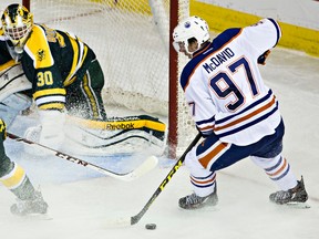 Edmonton's Connor McDavid (97) looks for a shot on University of Alberta's goalie Luke Siemens (30) during the second period of the Edmonton Oilers rookies' exhibition hockey game against the University of Alberta Golden Bears at Rexall Place in Edmonton, Alta. on Wednesday, Sept. 16, 2015. Codie McLachlan/Edmonton Sun/Postmedia Network