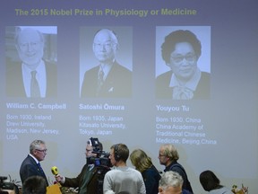 Hans Forssberg (front L), a member of the Karolinska Institute Nobel committee, talks to the media in front of a screen showing the 2015 Nobel laureates in medicine at the Karolinska Institute in Stockholm on Oct. 5, 2015. William Campbell, Satoshi Omura and Youyou Tu jointly won the 2015 Nobel Prize for medicine for their work against parasitic diseases, the award-giving body said on Monday. (REUTERS/Fredrik Sandberg/TT News Agency)