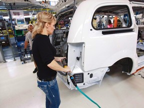 A worker on the production line at Chrysler's assembly plant in Windsor, Ont., works on one of their new minivans in this Jan. 18, 2011 file photo. The auto sector is one of the key sectors involved in the negotiations for the Trans-Pacific Partnership. (THE CANADIAN PRESS/Geoff Robins)
