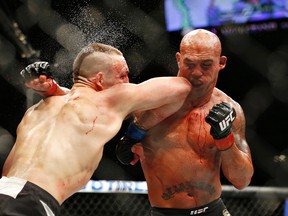 Rory MacDonald, left, and Robbie Lawler exchange blows in their welterweight title bout at UFC 189 on Saturday, July 11, 2015, in Las Vegas. (AP Photo/John Locher)