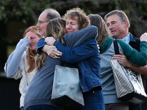 Faculty members embrace as they are allowed to return to Umpqua Community College Monday, Oct. 5, 2015, in Roseburg, Ore. The campus reopened to faculty for the first time since Oct. 1, when armed suspect Chris Harper-Mercer killed multiple people and wounded several others before taking his own life at Snyder Hall. (AP Photo/John Locher)