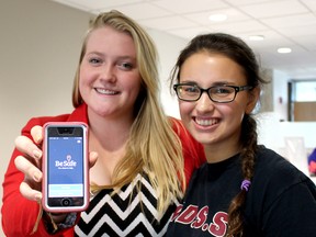 Katie Brandon-Wheeler, 18, a Grade 12 student at St. Patrick high school in Sarnia, Ontario, and Bridget Peters, 16, a Grade 11 student at Wallaceburg District Secondary School, display the new BeSafe App that is available free to students in both the Lambton Kent and St. Clair Catholic district school boards. Photo taken in Wallaceburg, Ont. on Monday October 5, 2015. (Ellwood Shreve, The Daily News)