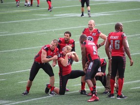Some of the Ottawa RedBlacks receivers clown around after a team picture was taken Monday at TD Place. (TIM BAINES/OTTAWA SUN)
