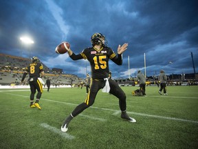 Hamilton Tiger-Cats quarterback Jeff Mathews warms up beneath a threatening, cold fall sky before action against the Calgary Stampeders at Tim Hortons Field in Hamilton on Oct. 2, 2015. (THE CANADIAN PRESS/Peter Power)