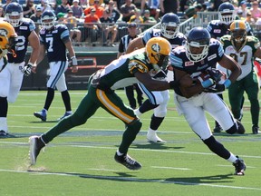 Argonauts wide receiver Tori Gurley (right) attempts to break free of a tackle during CFL action in Fort McMurray, Alta., on June 27, 2015. The Argonauts were forced out of their home at the Rogers Centre the first week of October due to playoff games involving the Blue Jays. (Robert Murray/Postmedia Network)