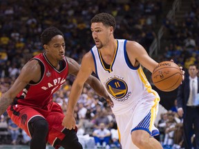 Warriors guard Klay Thompson dribbles the basketball against Raptors guard DeMar DeRozan on Oct. 5, 2015 at the SAP Center. (USA Today Sports)