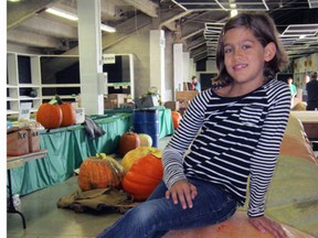 Brooklyn Jarvis, 8, of St. Thomas, is proud of this 1,104 pound pumpkin grown by her father, Joel. For the third year in a row, Joel Jarvis claimed the $2,000 first prize Sunday for the largest pumpkin entered at the Norfolk County Fair.