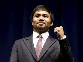 Eight-division world champion Manny "Pac-Man" Pacquiao attends a news conference in Los Angeles, Calif., in this March 11, 2015 file photo. Philippine boxing world champion and congressman Pacquiao has announced Oct. 6, 2015, he will take up a new challenge by running for a Senate seat in national elections next year. (REUTERS/Lucy Nicholson/Files)